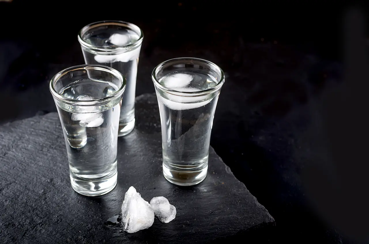 three-vodka-shots-with-ice-on-black-table-copy-sp-2021-09-03-05-48-29-utc